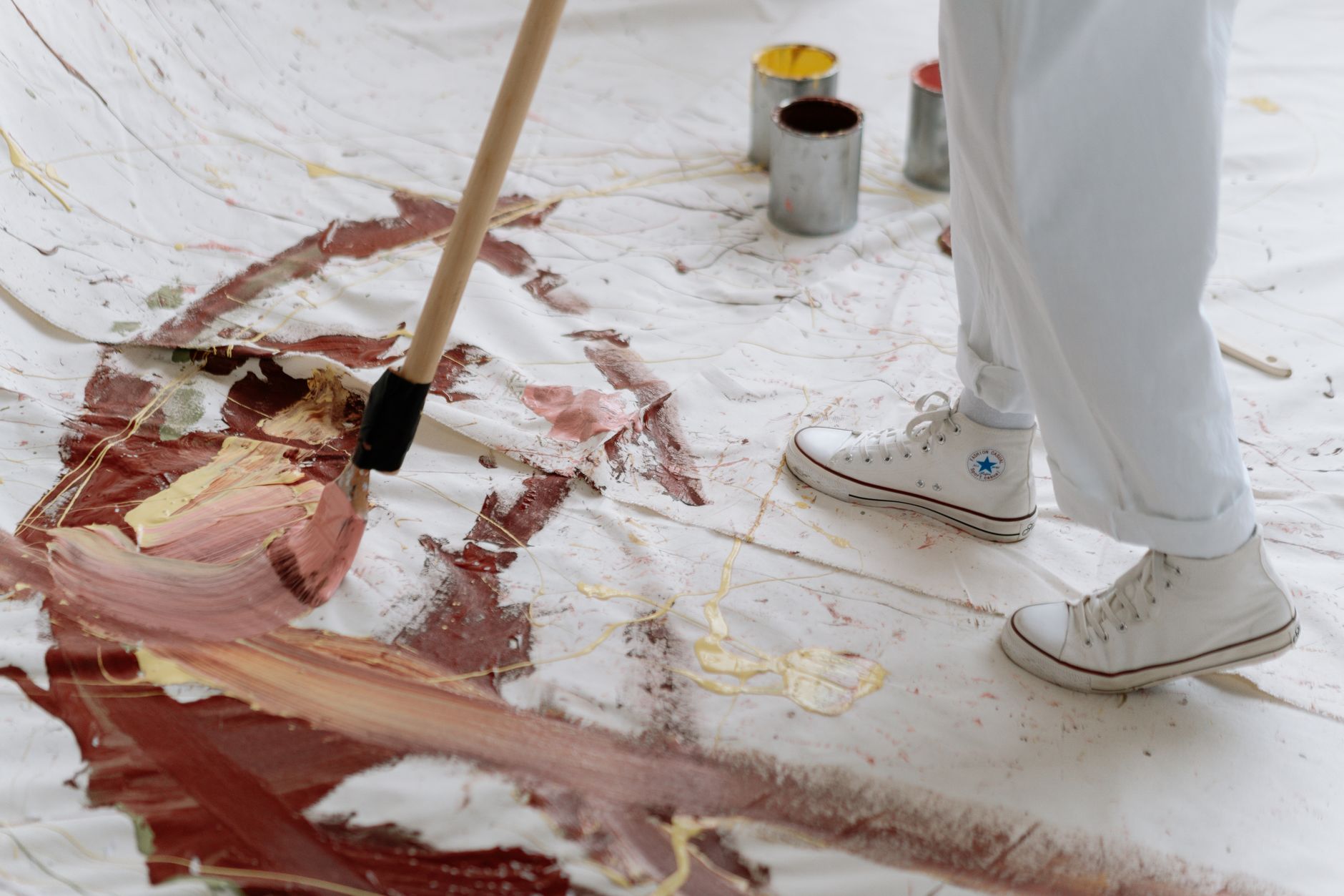Artist working on a handmade piece at a studio table